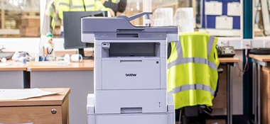 Brother floor standing printer in warehouse office, hi-vis, window, paperwork